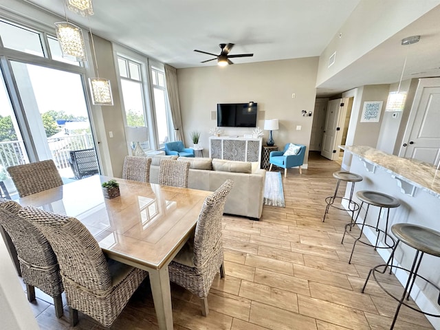 9100 Baytowne Wharf Boulevard 470/472, Walton Beaches, FL 32550 - dining room featuring light wood-style flooring, a ceiling fan, and a chandelier