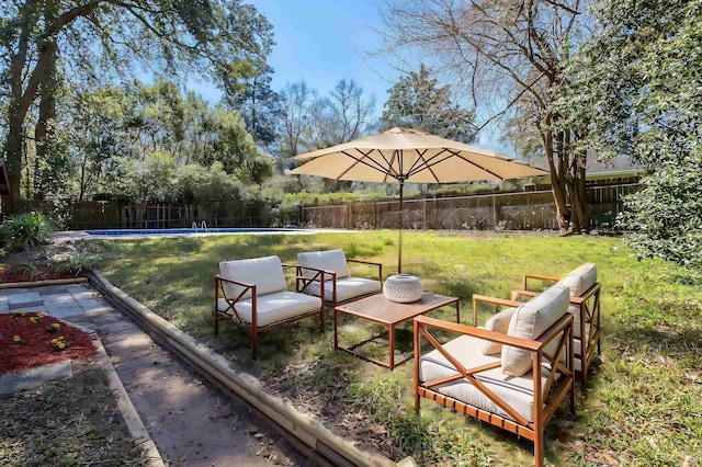 view of yard featuring outdoor lounge area, a fenced backyard, and a fenced in pool