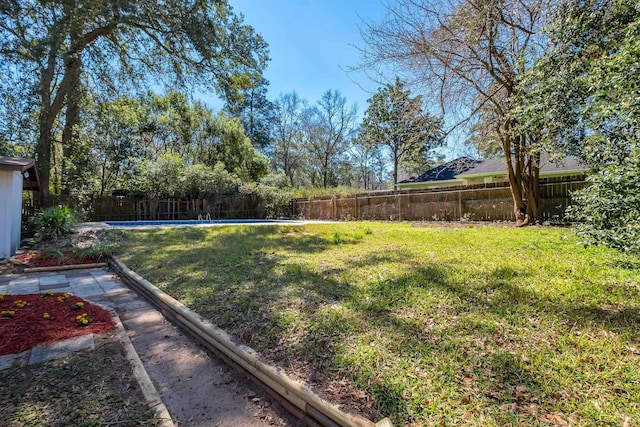 view of yard with a fenced in pool and a fenced backyard