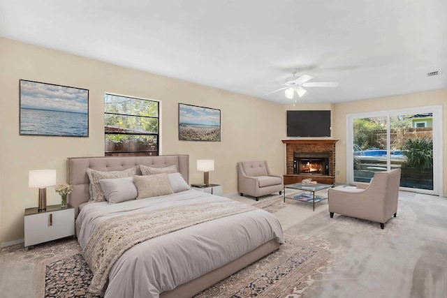 bedroom with access to exterior, baseboards, a fireplace, and visible vents