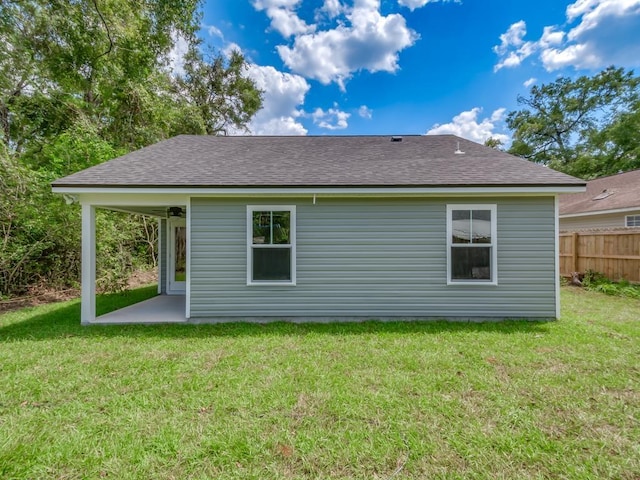 back of house featuring a lawn and a patio