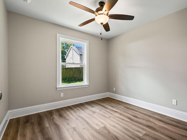 spare room featuring light wood-type flooring and ceiling fan