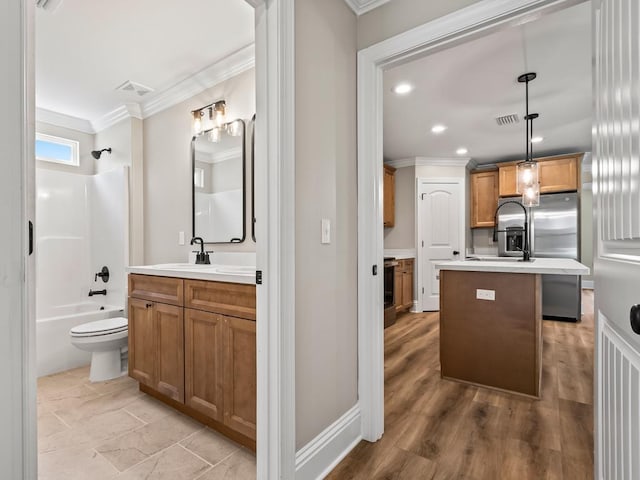 full bathroom with wood-type flooring, vanity, shower / washtub combination, toilet, and crown molding