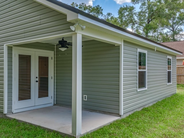 view of side of property with ceiling fan, a patio area, and french doors