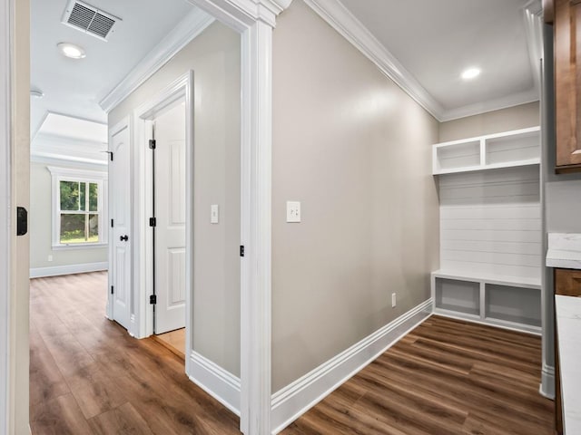 hallway with dark hardwood / wood-style floors and crown molding