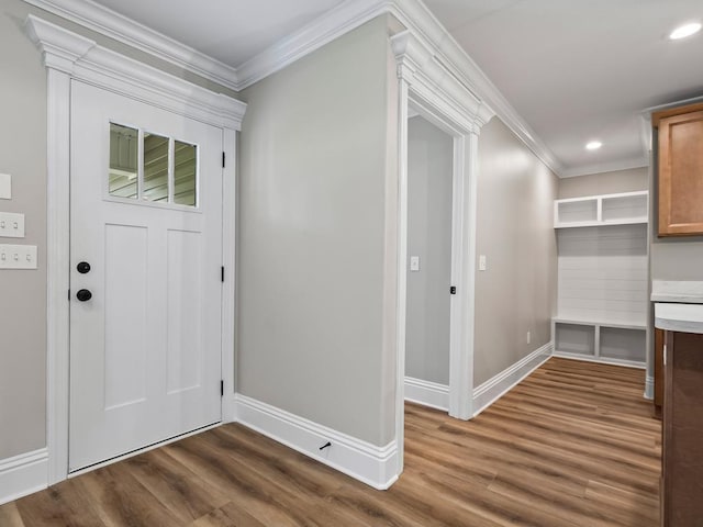 foyer entrance with dark wood-type flooring and ornamental molding