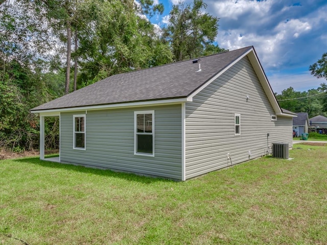 view of property exterior with a yard and central air condition unit