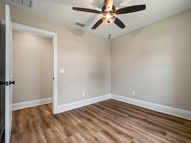 empty room featuring ceiling fan and wood-type flooring