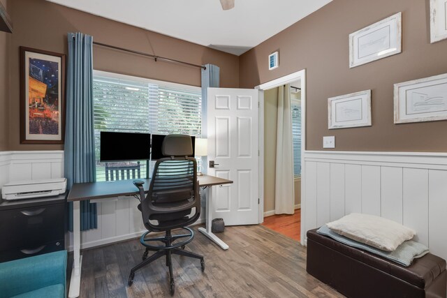 4557 Running Meadows Ln, Tallahassee, FL 32303 - home office featuring wainscoting, wood finished floors, and a decorative wall