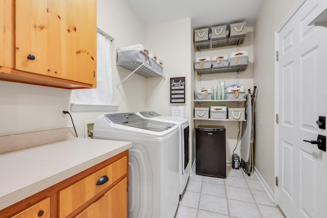 4557 Running Meadows Ln, Tallahassee, FL 32303 - washroom featuring light tile patterned floors, cabinet space, and washer and dryer
