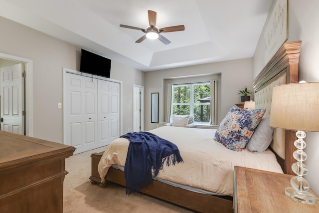 4557 Running Meadows Ln, Tallahassee, FL 32303 - carpeted bedroom with a tray ceiling, a ceiling fan, and a closet