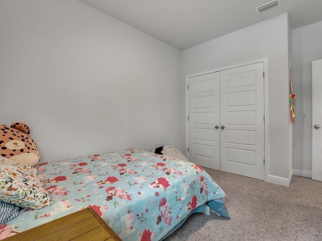 carpeted bedroom with a closet