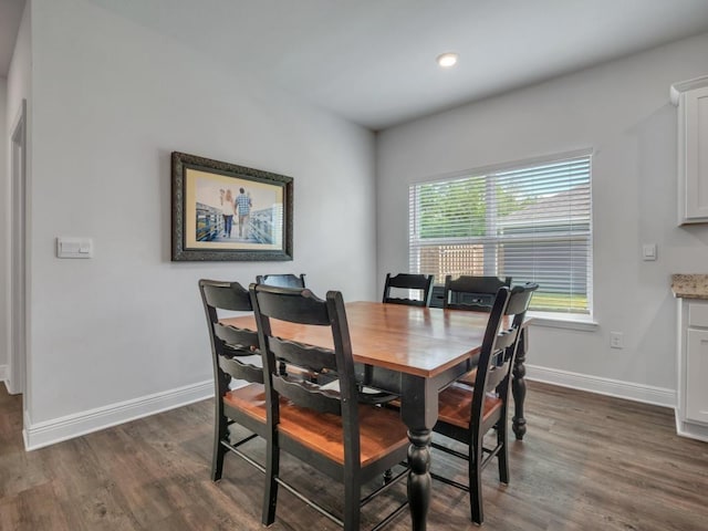 dining space with dark hardwood / wood-style floors