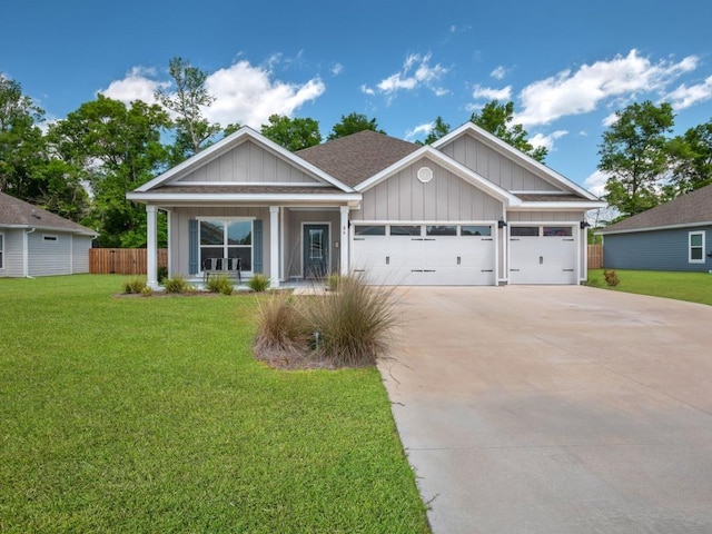 craftsman house with a garage, covered porch, and a front yard