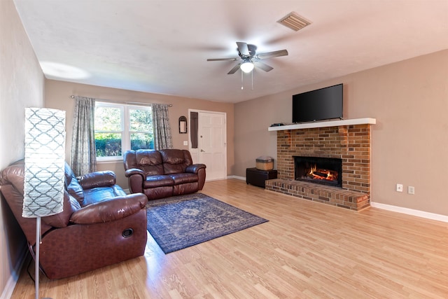 living room featuring a fireplace, wood finished floors, and baseboards