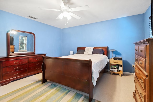 bedroom featuring carpet floors, visible vents, and a ceiling fan