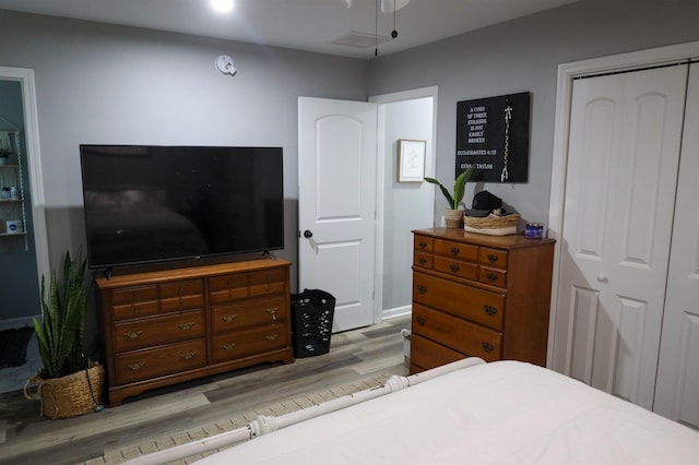 bedroom with a closet and wood finished floors