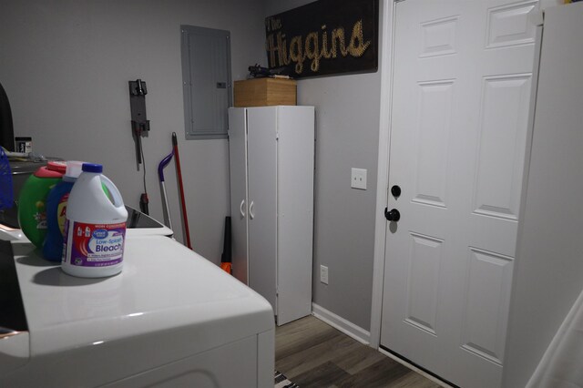 washroom with dark wood finished floors, electric panel, baseboards, and washer / clothes dryer