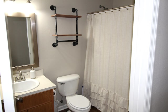 bathroom with vanity, a shower with shower curtain, and toilet