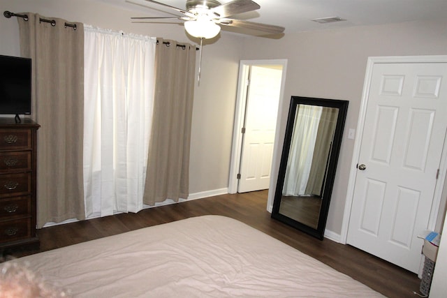 bedroom with ceiling fan and dark hardwood / wood-style flooring