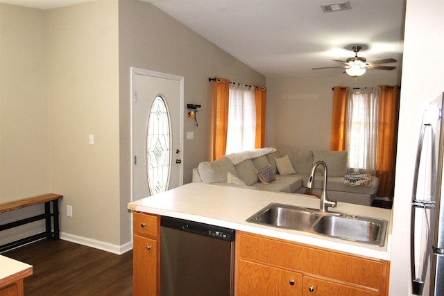 kitchen with dark wood-type flooring, sink, vaulted ceiling, ceiling fan, and stainless steel appliances