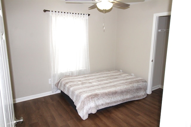 bedroom featuring dark hardwood / wood-style flooring and ceiling fan