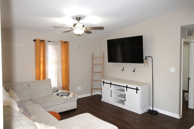 living room featuring ceiling fan and dark hardwood / wood-style flooring