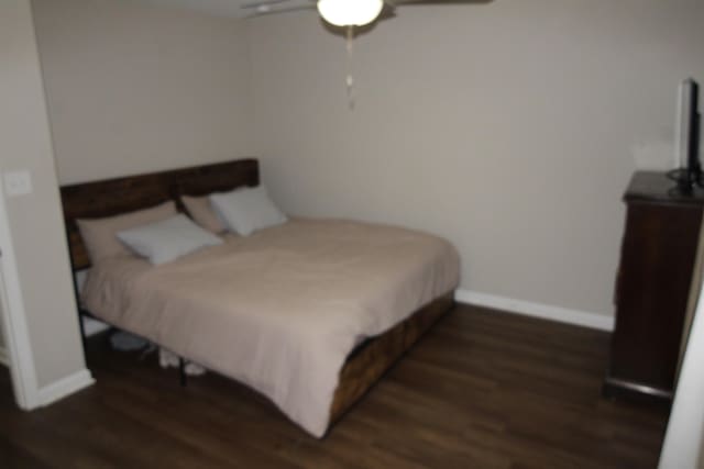 bedroom featuring dark hardwood / wood-style flooring and ceiling fan