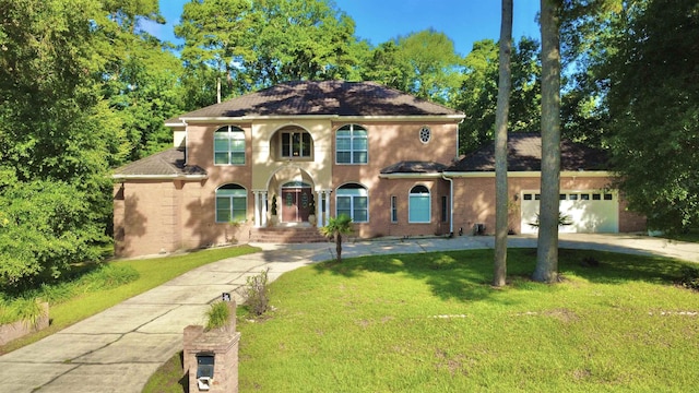 10 Yvonne Ct, Havana, FL 32333 - mediterranean / spanish-style home featuring a garage, driveway, a front yard, and brick siding