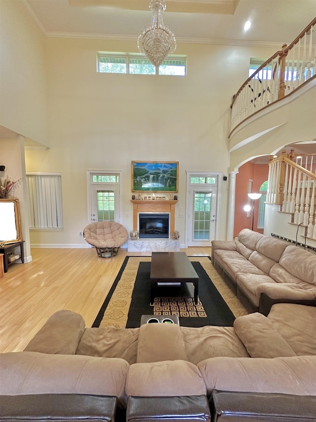 10 Yvonne Ct, Havana, FL 32333 - living area with wood finished floors, a high ceiling, ornamental molding, a glass covered fireplace, and stairs