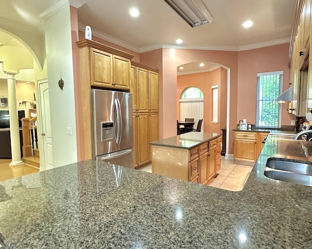 10 Yvonne Ct, Havana, FL 32333 - kitchen with stainless steel refrigerator with ice dispenser, arched walkways, dark stone countertops, decorative columns, and range hood