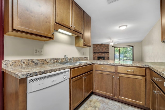 2398 Continental Ave, Tallahassee, FL 32304 - kitchen featuring dishwasher, ceiling fan, a brick fireplace, and brown cabinetry