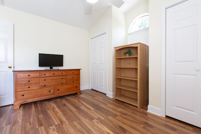 unfurnished bedroom featuring ceiling fan, dark wood-type flooring, and vaulted ceiling