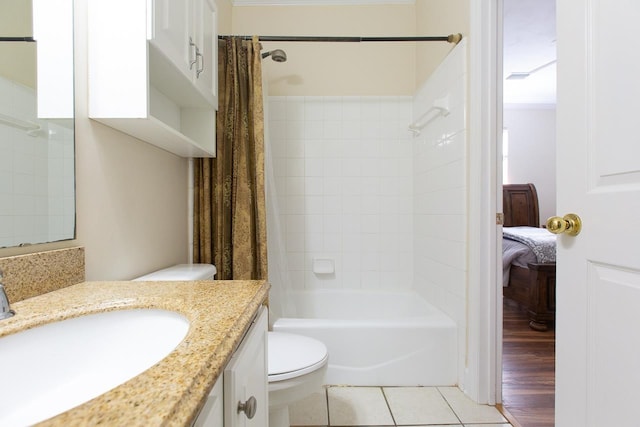 full bathroom featuring tile patterned flooring, vanity, toilet, and shower / bath combo with shower curtain