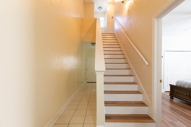 stairway with tile patterned floors