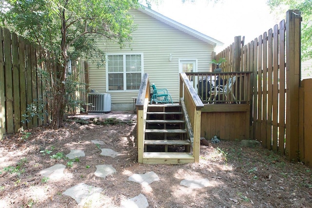 rear view of house with a deck and central AC unit