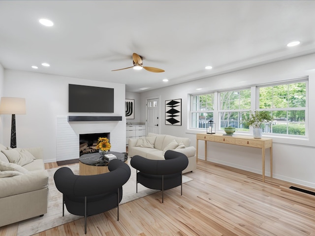 1102 Betton Rd, Tallahassee, FL 32308 - living room featuring light wood-type flooring, a ceiling fan, a brick fireplace, recessed lighting, and baseboards