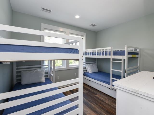 bedroom with dark wood-style floors, recessed lighting, and visible vents