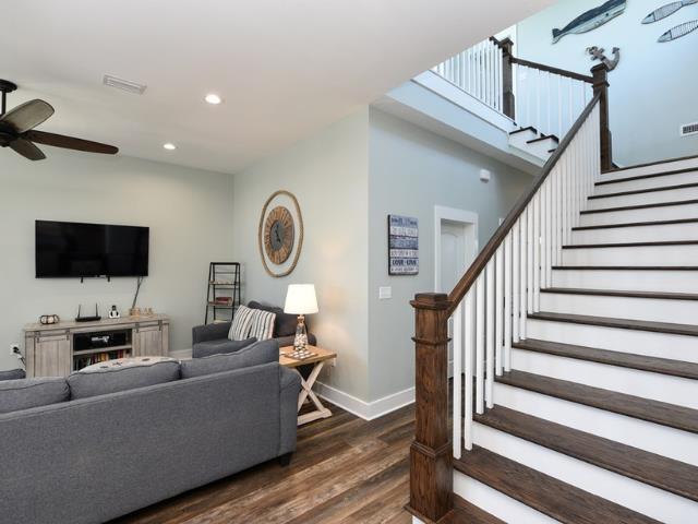 living room with recessed lighting, dark wood-type flooring, a ceiling fan, baseboards, and stairway