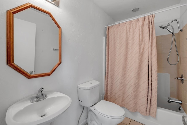 full bathroom with tile patterned flooring, sink, toilet, and shower / bath combo