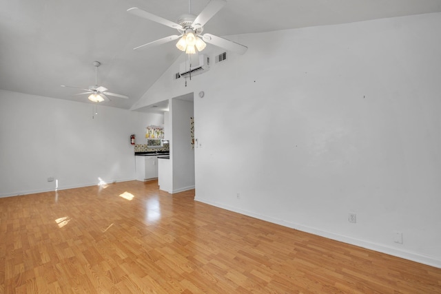 unfurnished living room with ceiling fan, high vaulted ceiling, and light hardwood / wood-style floors