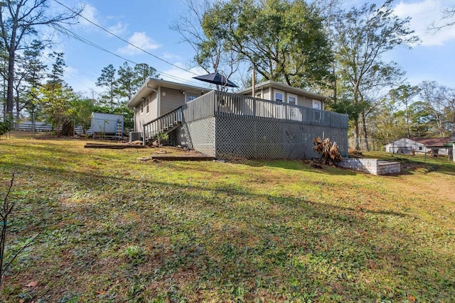 view of yard featuring a wooden deck and central AC