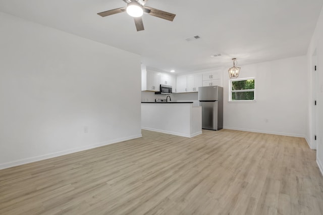 3204 N Ridge Rd, Tallahassee, FL 32305 - unfurnished living room with ceiling fan, light wood-style flooring, a chandelier, and recessed lighting