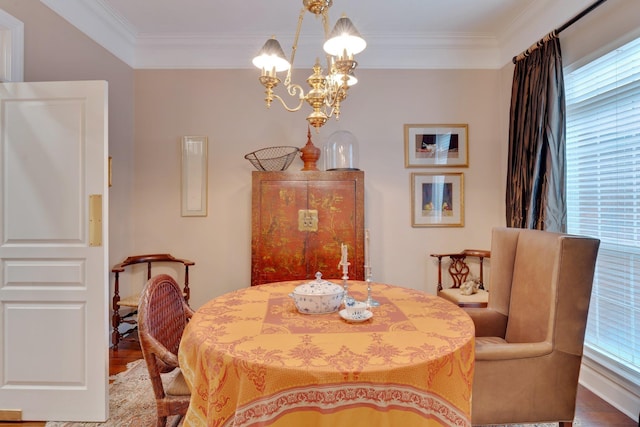 dining space with a notable chandelier, hardwood / wood-style flooring, and ornamental molding