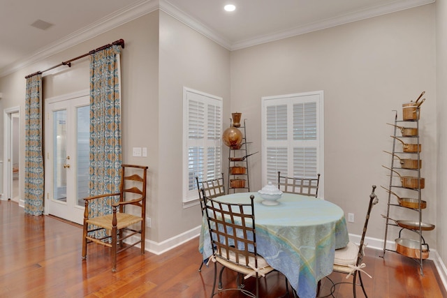 dining area featuring crown molding and wood-type flooring