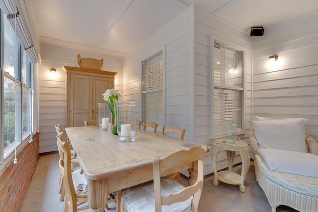 dining room with wood walls