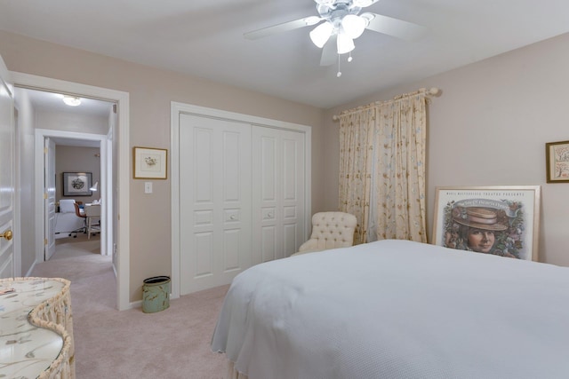 bedroom with light carpet, ceiling fan, and a closet