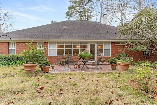 back of property featuring a yard and a patio area