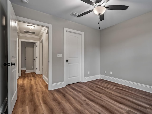 spare room with ceiling fan, dark hardwood / wood-style flooring, and ornamental molding