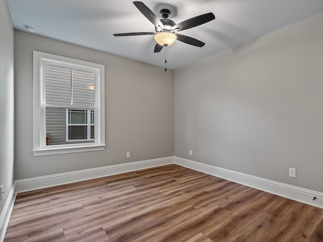 spare room with ceiling fan and wood-type flooring